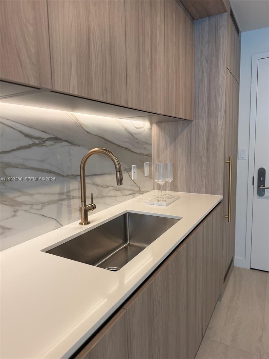 77 Southeast 5th Street, Unit 1608 Miami, FL 33131 - Photo 3 of 44 a close view of sink and tap