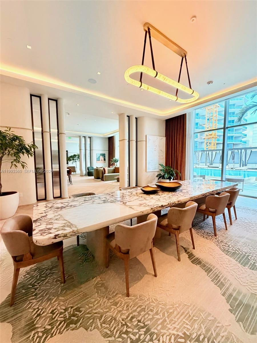 77 Southeast 5th Street, Unit 1608 Miami, FL 33131 - Photo 33 of 44 a outdoor space with lots of furniture a rug and white walls