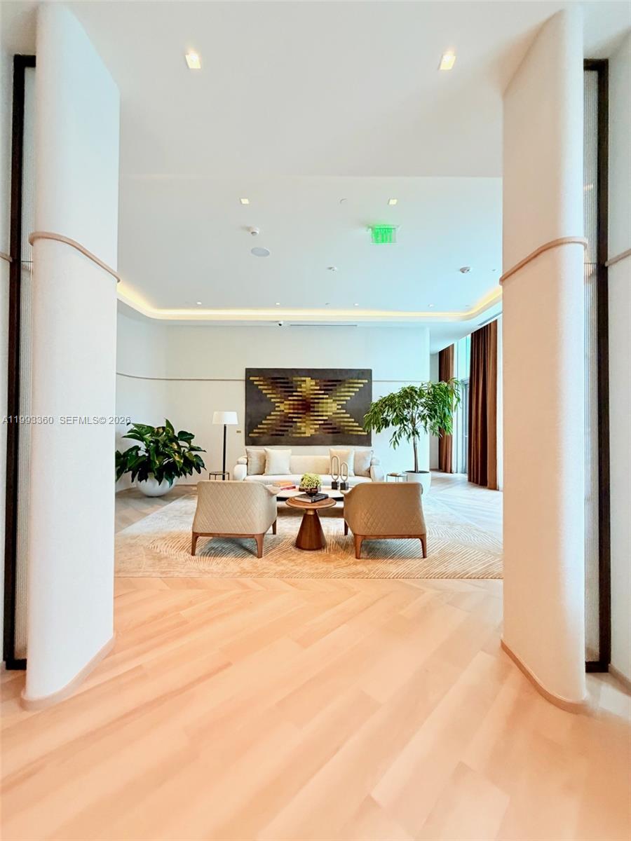 77 Southeast 5th Street, Unit 1608 Miami, FL 33131 - Photo 35 of 44 a living room with furniture and a flat screen tv