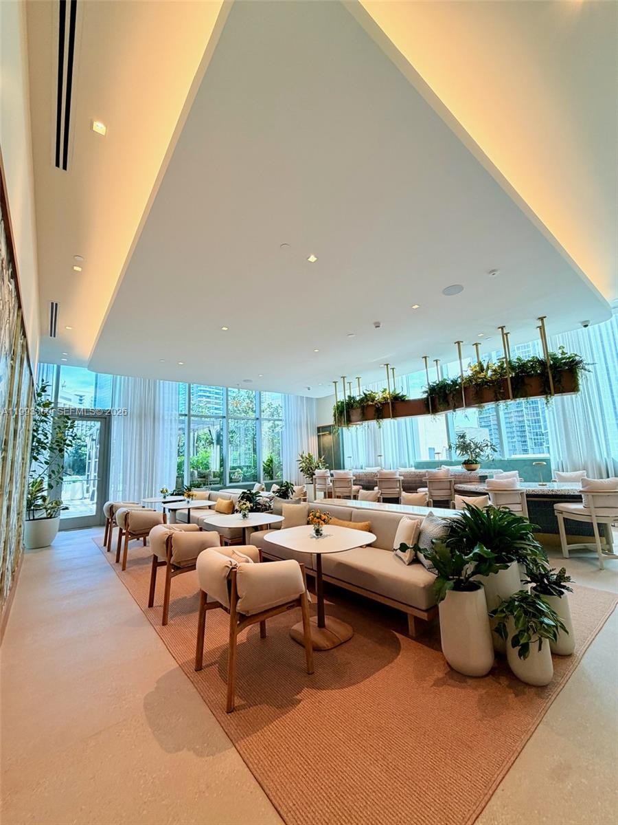 77 Southeast 5th Street, Unit 1608 Miami, FL 33131 - Photo 38 of 44 a living room with furniture and a potted plant