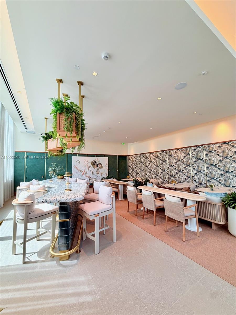 77 Southeast 5th Street, Unit 1608 Miami, FL 33131 - Photo 39 of 44 a view of a patio with table and chairs potted plants