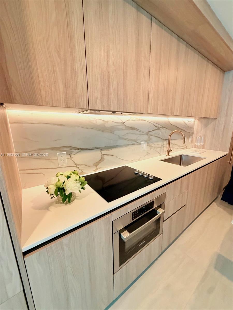 77 Southeast 5th Street, Unit 1608 Miami, FL 33131 - Photo 4 of 44 a close view of sink and microwave