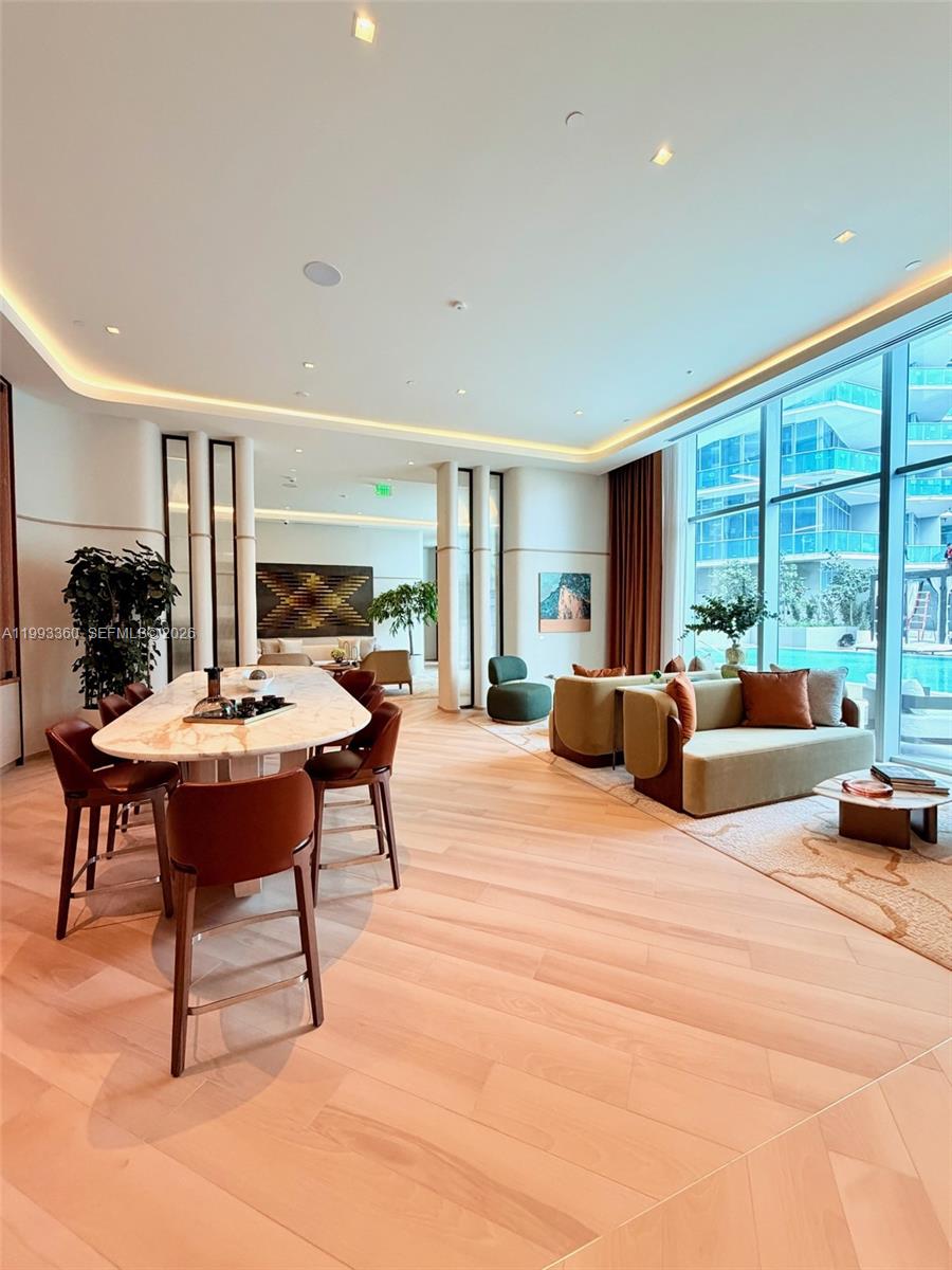 77 Southeast 5th Street, Unit 1608 Miami, FL 33131 - Photo 42 of 44 a living room with furniture and a large window