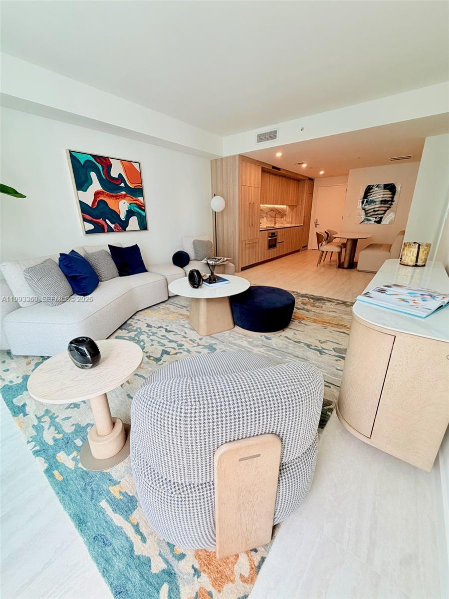 77 Southeast 5th Street, Unit 1608 Miami, FL 33131 - Photo 8 of 44 a bedroom with a bed and a large mirror on the dresser