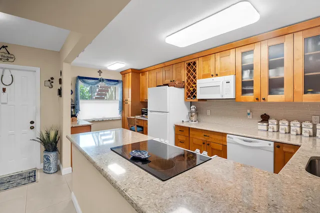 a kitchen with stainless steel appliances kitchen island a cabinets and wooden floor