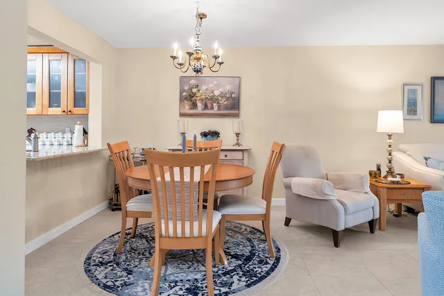 a view of a dining room with furniture a livingroom and chandelier