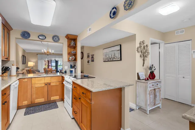 a kitchen with stainless steel appliances granite countertop a stove and cabinets