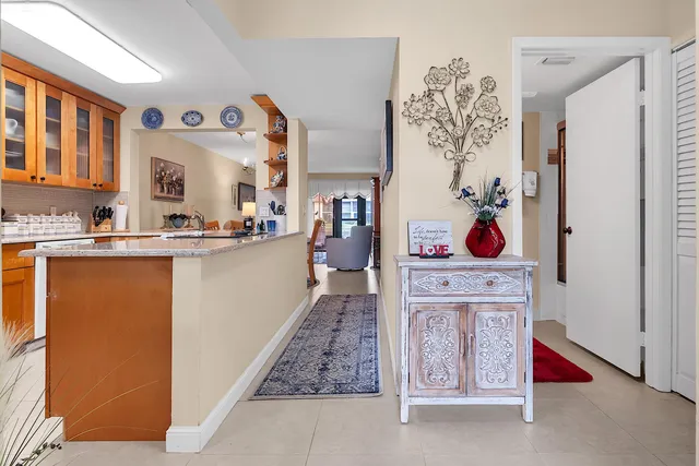 a living room with stainless steel appliances kitchen island granite countertop a refrigerator and a stove