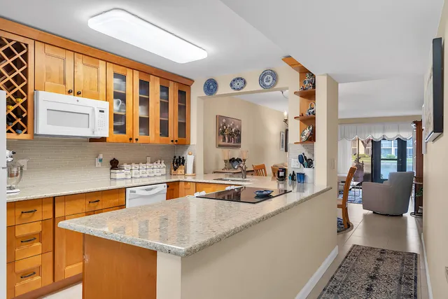 a kitchen with stainless steel appliances granite countertop a sink and a refrigerator