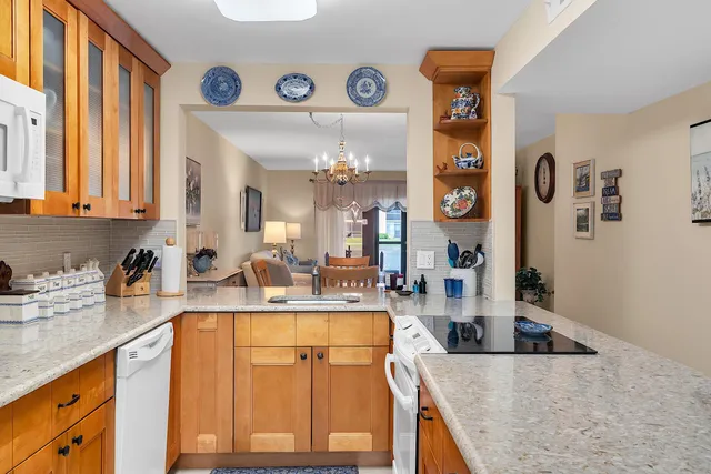 a kitchen with stainless steel appliances granite countertop a sink and dishwasher cabinets with wooden floor