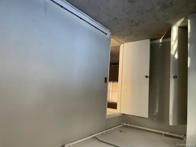 488 Nassau Road, Unit 1 Roosevelt, NY 11575 - Photo 2 of 2 Carpeted spare room featuring a baseboard radiator