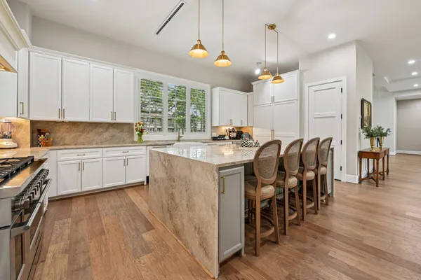 a kitchen with a table chairs sink and cabinets