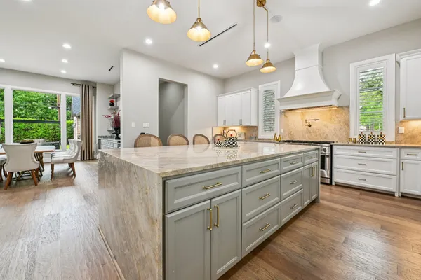a spacious bathroom with double vanity and a large mirror