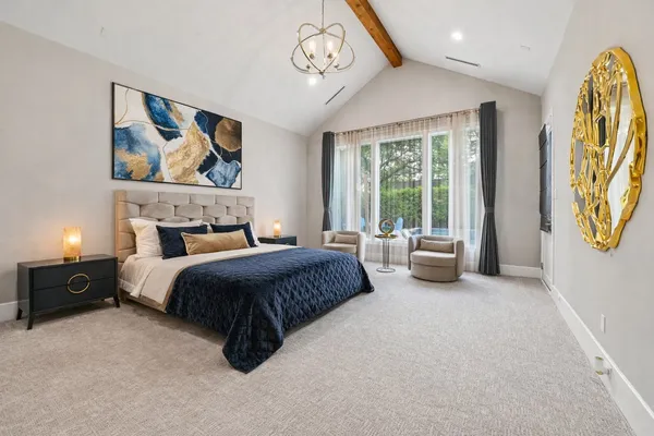 a bedroom with a bed couch and window