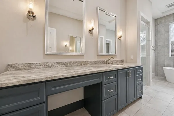 a bathroom with a granite countertop sink a mirror and a