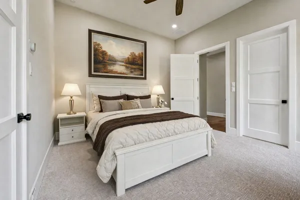 a bedroom with a bed and a painting on the wall