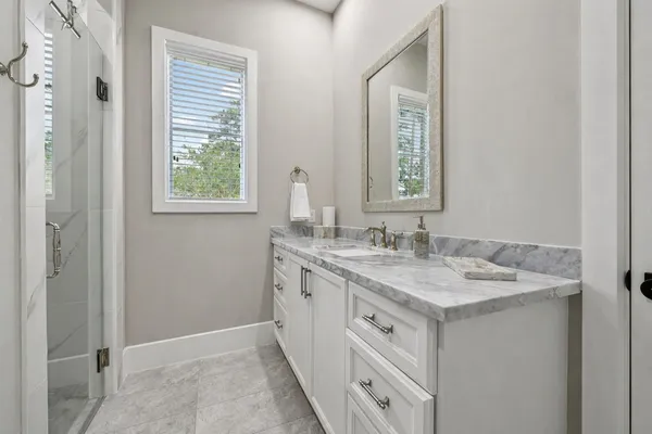 a bathroom with a sink vanity and a mirror