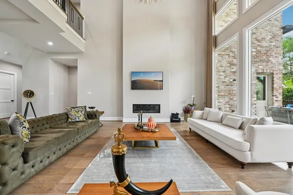 a living room with furniture a large window and a flat screen tv