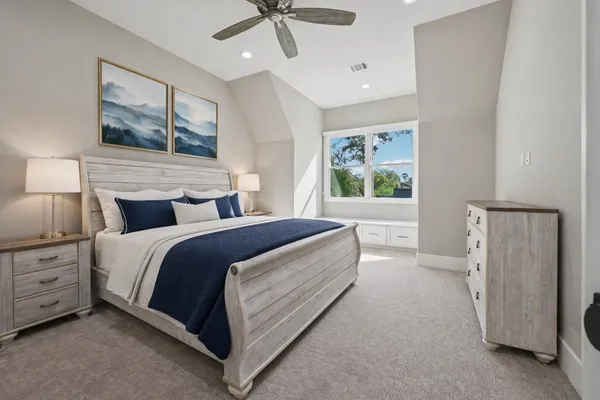 a spacious bedroom with a bed and window