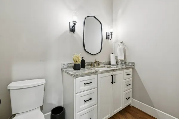 a bathroom with a toilet sink and mirror