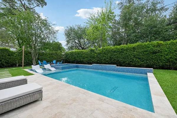 a view of a backyard with swimming pool