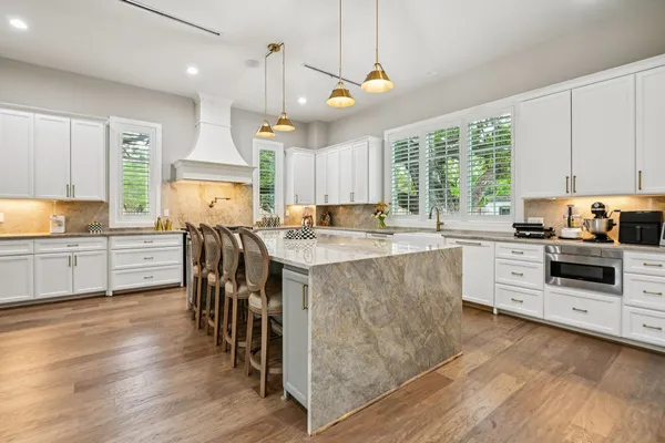 a kitchen with stainless steel appliances sink stove top oven and cabinets