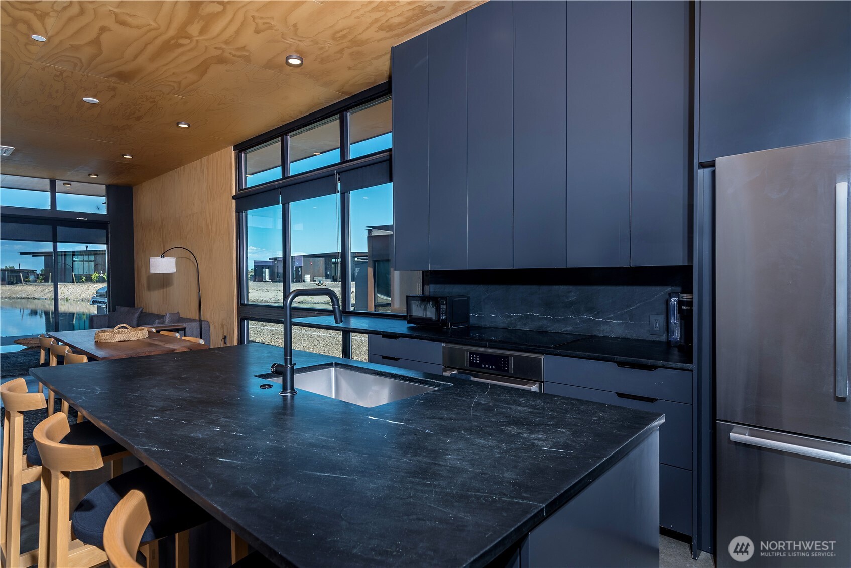23592 Gorge View Loop Northwest Quincy, WA 98848 - Photo 16 of 24 a kitchen with a table chairs and a refrigerator