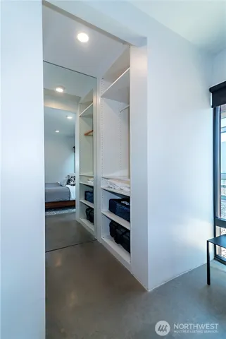 a view of a hallway to rooms and stairs