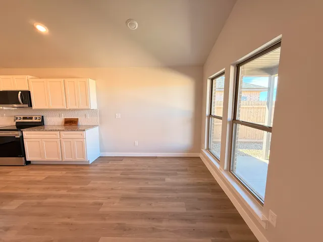 a view of kitchen with microwave and window