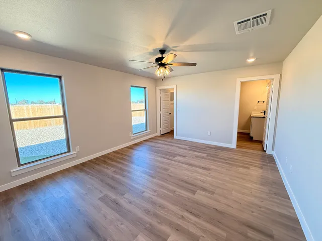 wooden floor in an empty room with a window