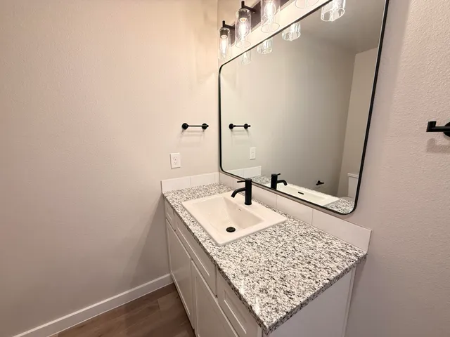 a bathroom with a sink and mirror