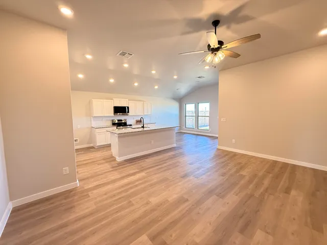 a view of kitchen with cabinets and wooden floor