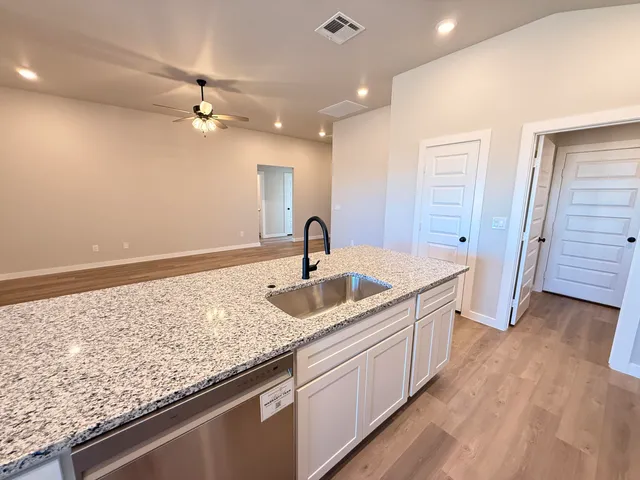 a kitchen with a sink and cabinets