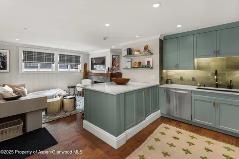 a kitchen with stainless steel appliances kitchen island granite countertop a sink and cabinets