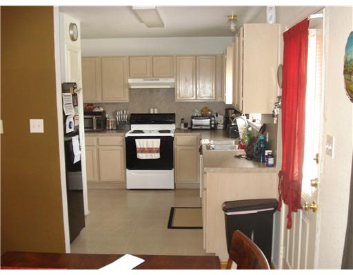 1825 Modesto Street Corpus Christi, TX 78417 - Photo 2 of 4 a kitchen with stainless steel appliances granite countertop a refrigerator a stove top oven a sink and dishwasher