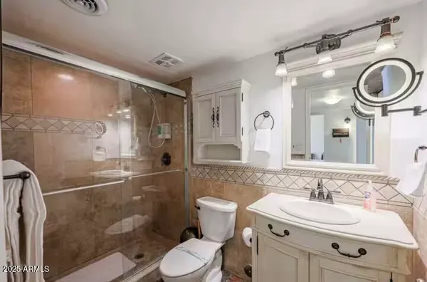 a bathroom with a sink a toilet and a mirror