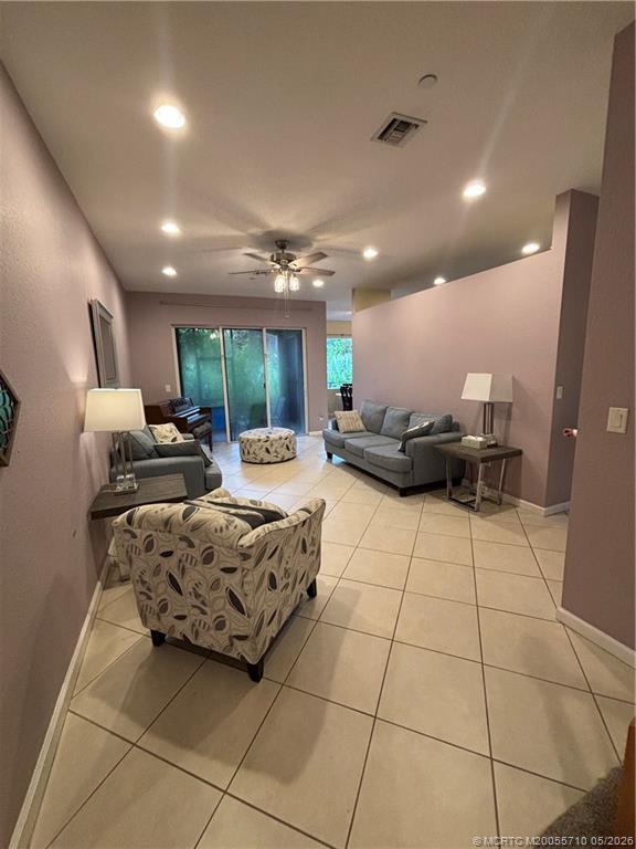262 Southwest Walking Path, Unit 262 Stuart, FL 34997 - Photo 14 of 39 a living room with furniture and a chandelier