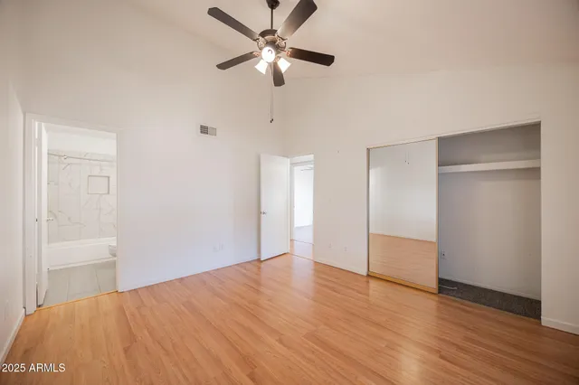 a view of empty room with wooden floor