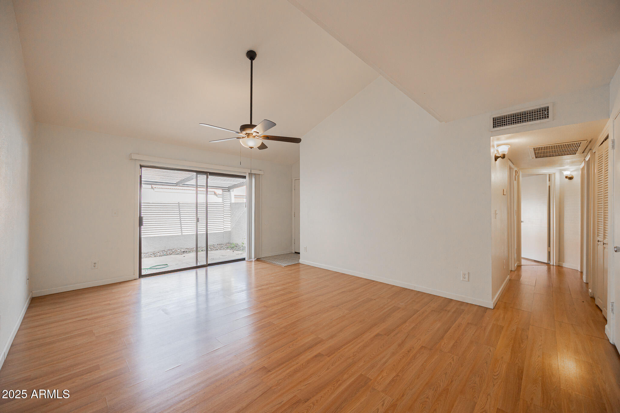 2141 East Kirkland Lane, Unit 4 Tempe, AZ 85281 - Photo 5 of 21 a view of an empty room with wooden floor and a window