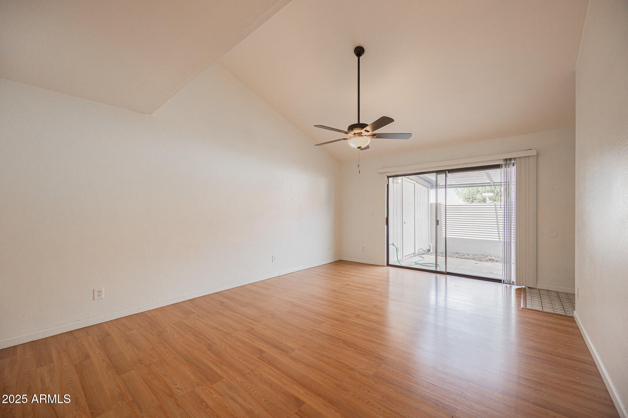 2141 East Kirkland Lane, Unit 4 Tempe, AZ 85281 - Photo 6 of 21 a view of an empty room with a window and wooden floor