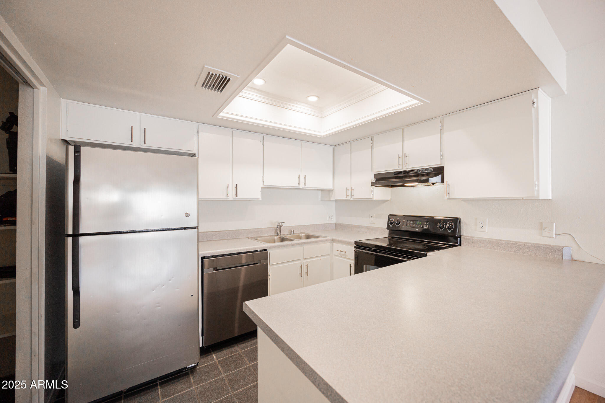 2141 East Kirkland Lane, Unit 4 Tempe, AZ 85281 - Photo 8 of 21 a kitchen with refrigerator a stove a sink and white cabinets