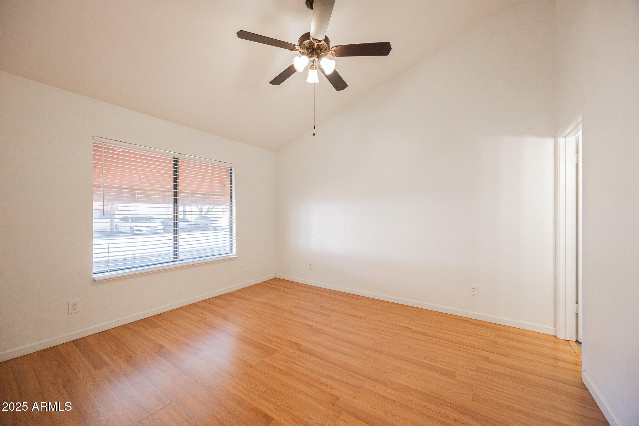 2141 East Kirkland Lane, Unit 4 Tempe, AZ 85281 - Photo 10 of 21 wooden floor in an empty room with a window