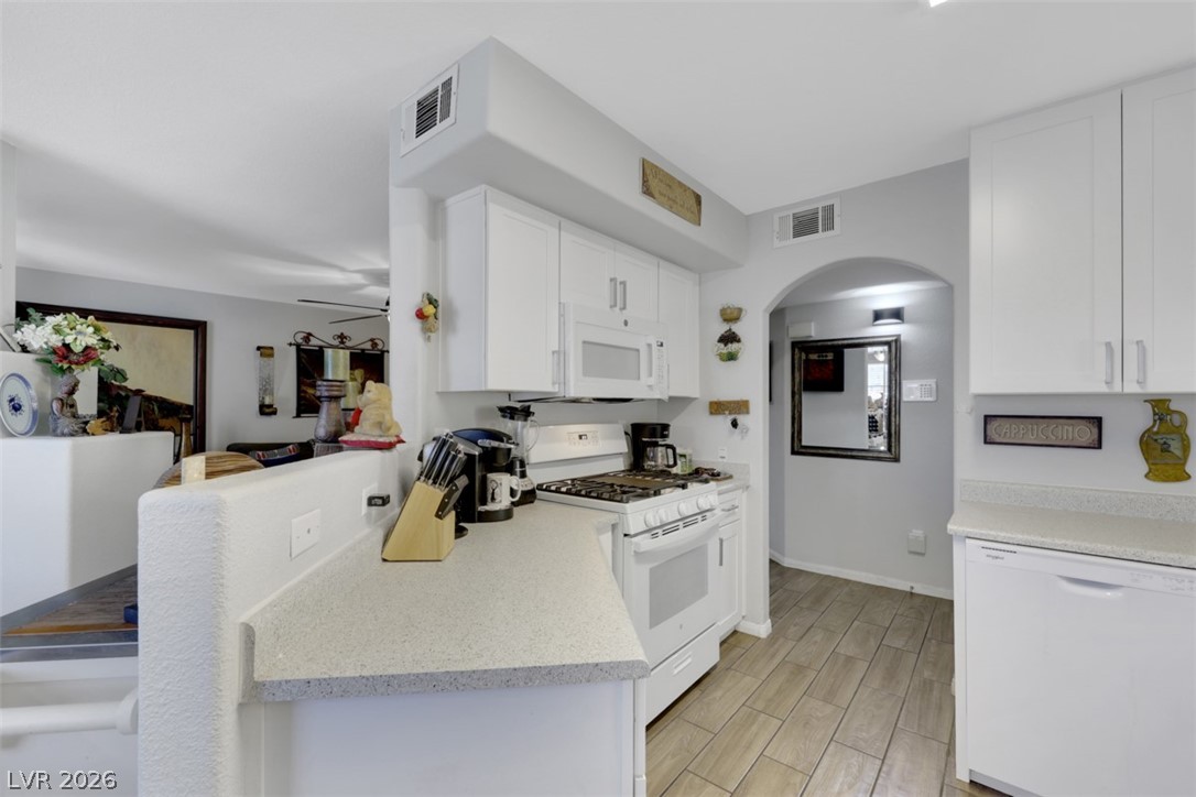 698 South Racetrack Road, Unit 1614 Henderson, NV 89015 - Photo 26 of 35 Bright and functional, this kitchen features sleek white cabinetry and durable countertops, perfect for daily living.