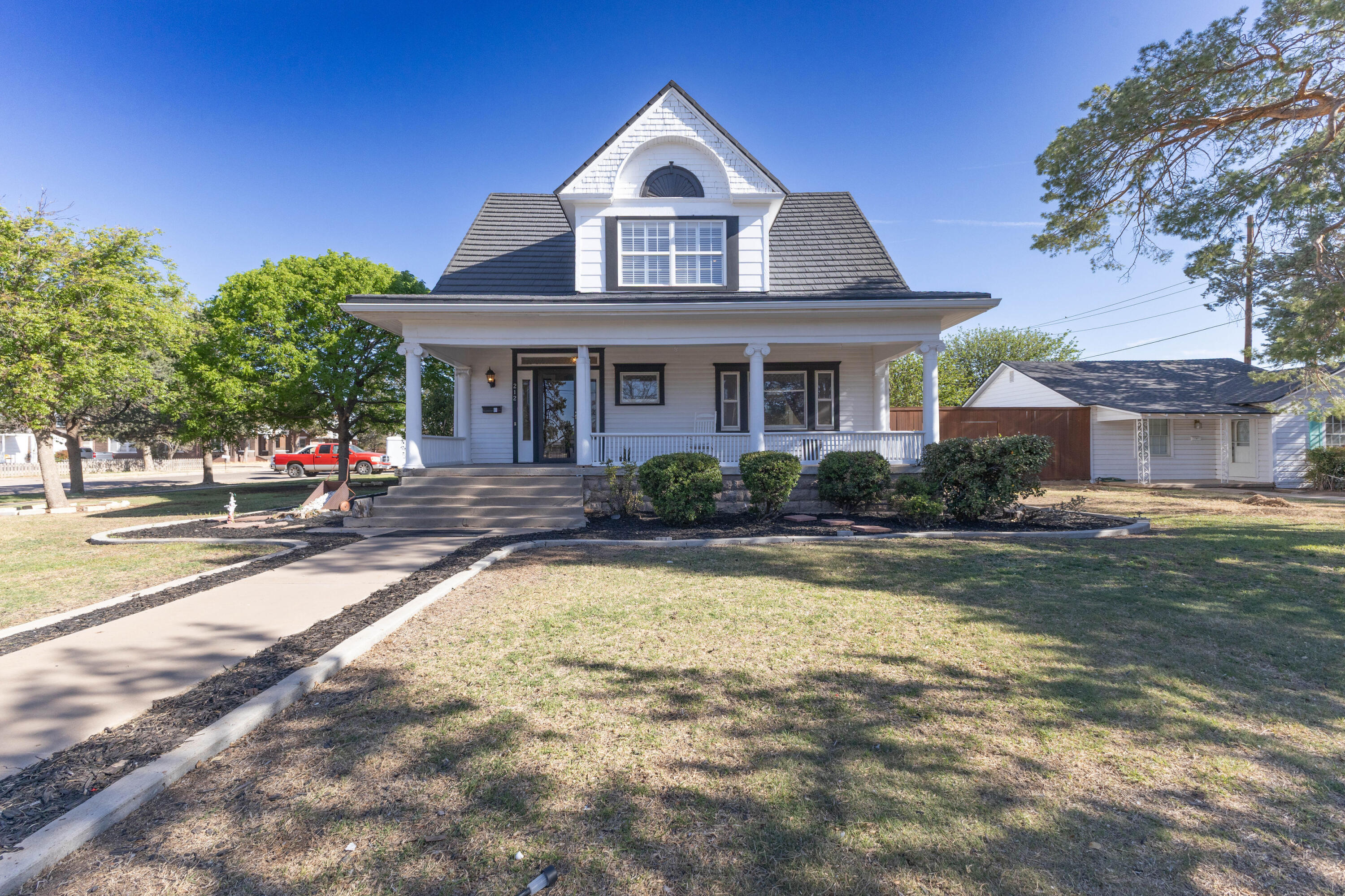 212 West 9th Street Plainview, TX 79072 - Photo 1 of 35 a front view of a house with swimming pool