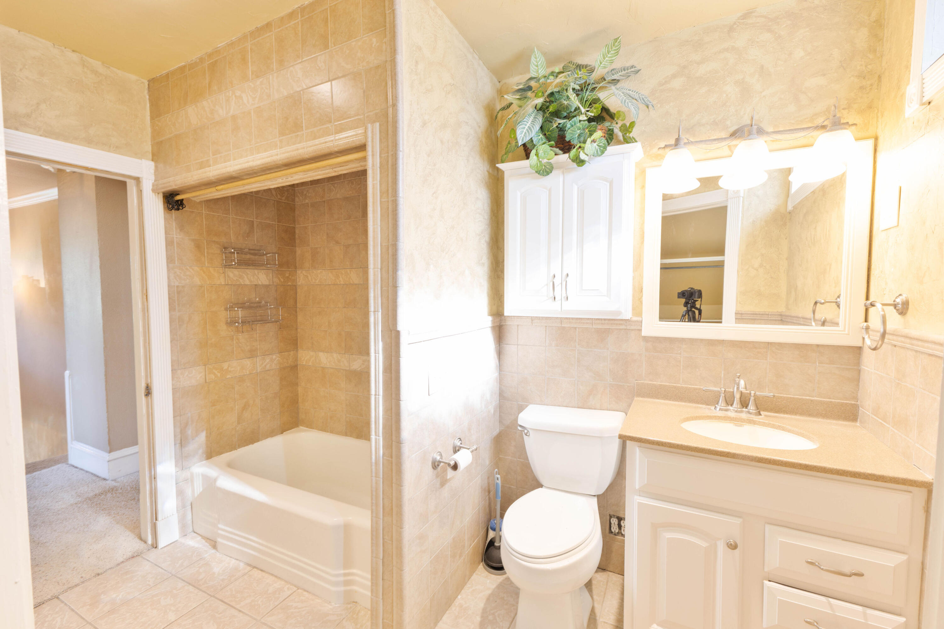 212 West 9th Street Plainview, TX 79072 - Photo 21 of 35 a bathroom with a granite countertop sink toilet and shower