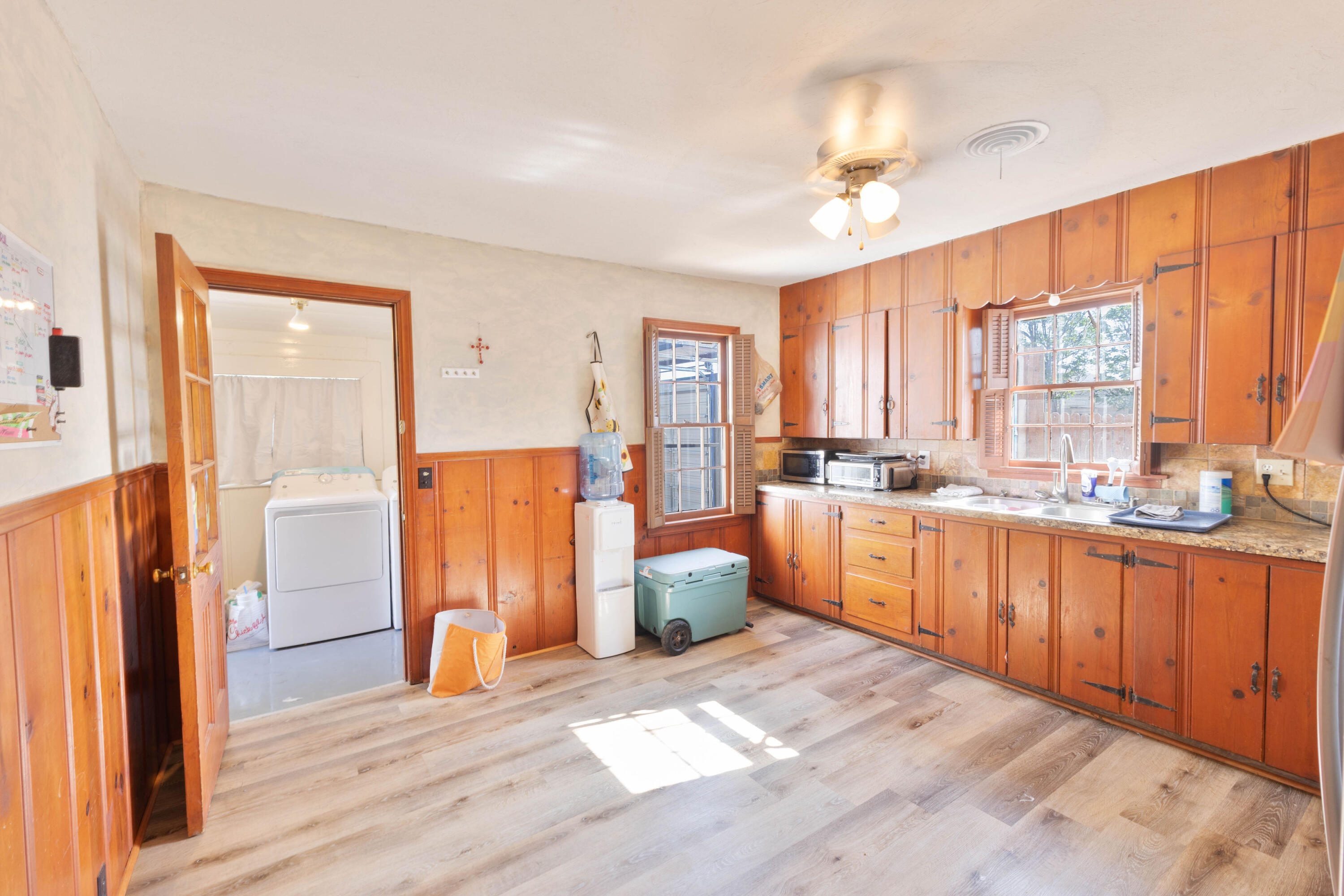 212 West 9th Street Plainview, TX 79072 - Photo 28 of 35 a large kitchen with a window and wooden cabinets