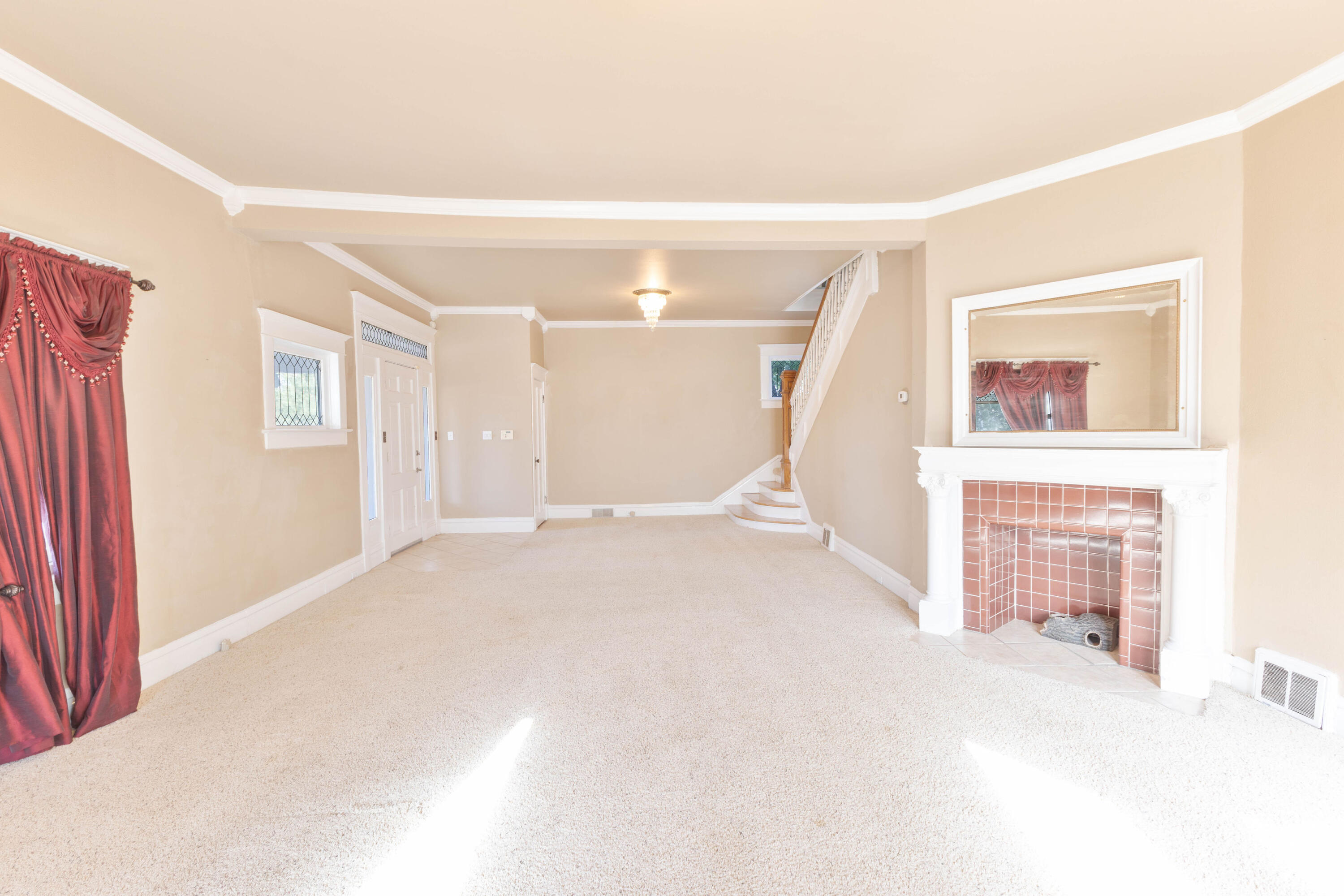 212 West 9th Street Plainview, TX 79072 - Photo 4 of 35 a view of an empty room with a fireplace