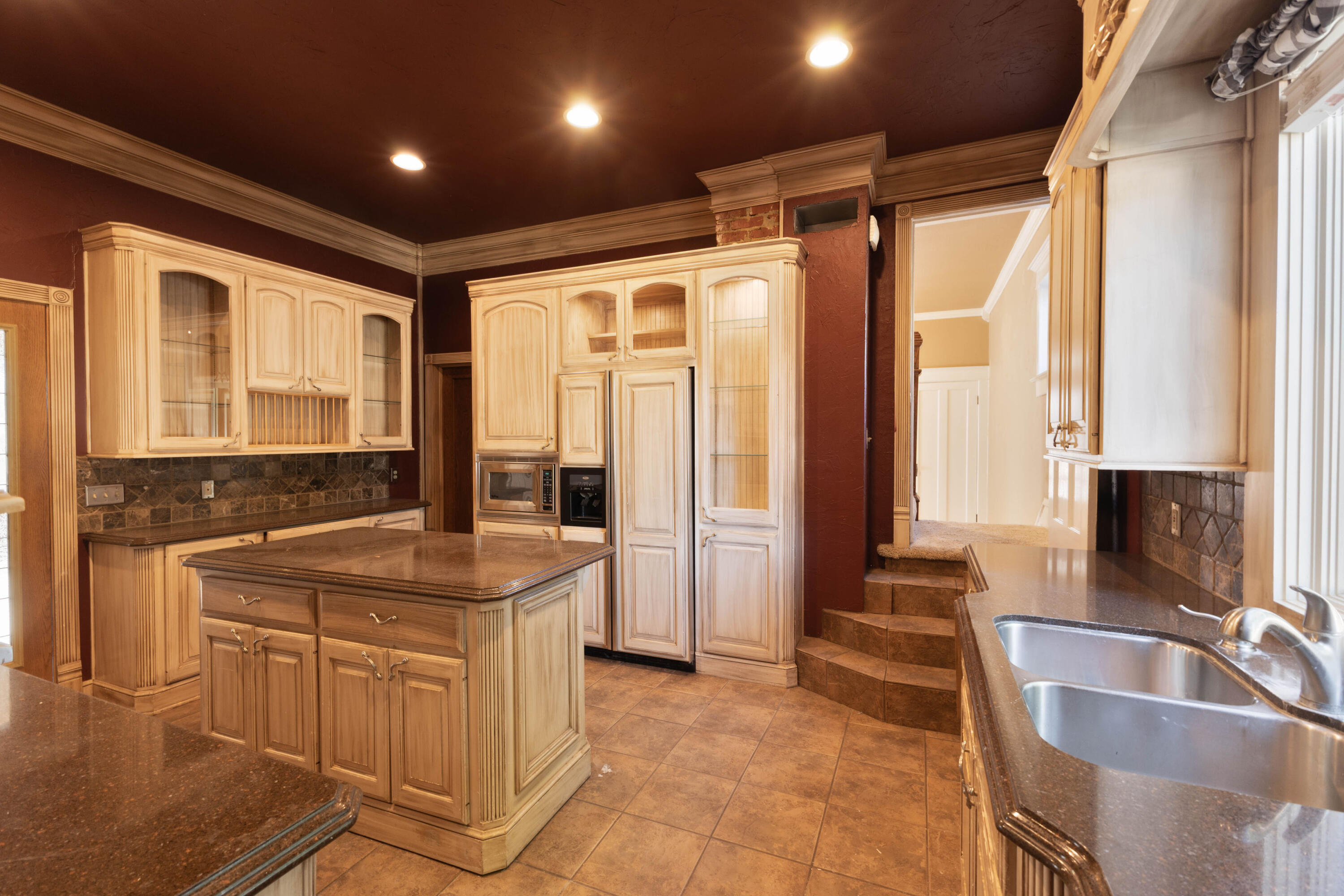 212 West 9th Street Plainview, TX 79072 - Photo 8 of 35 a kitchen with a sink and a refrigerator