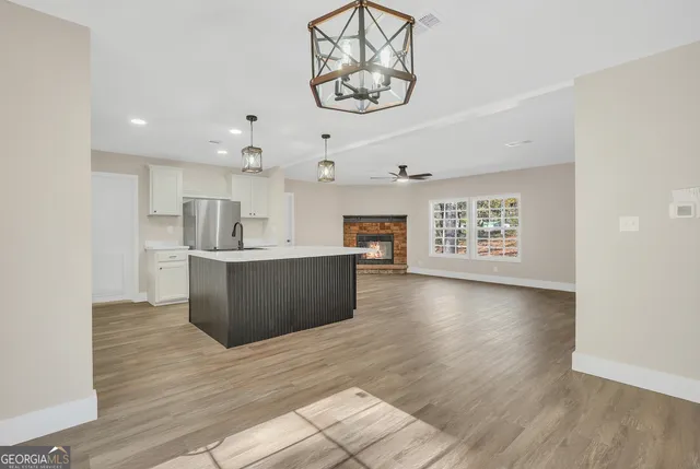 a view of kitchen with cabinets and wooden floor