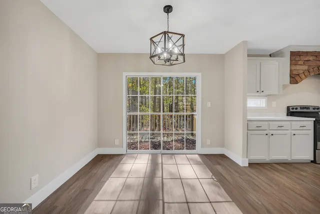 a view of a room with wooden floor and windows